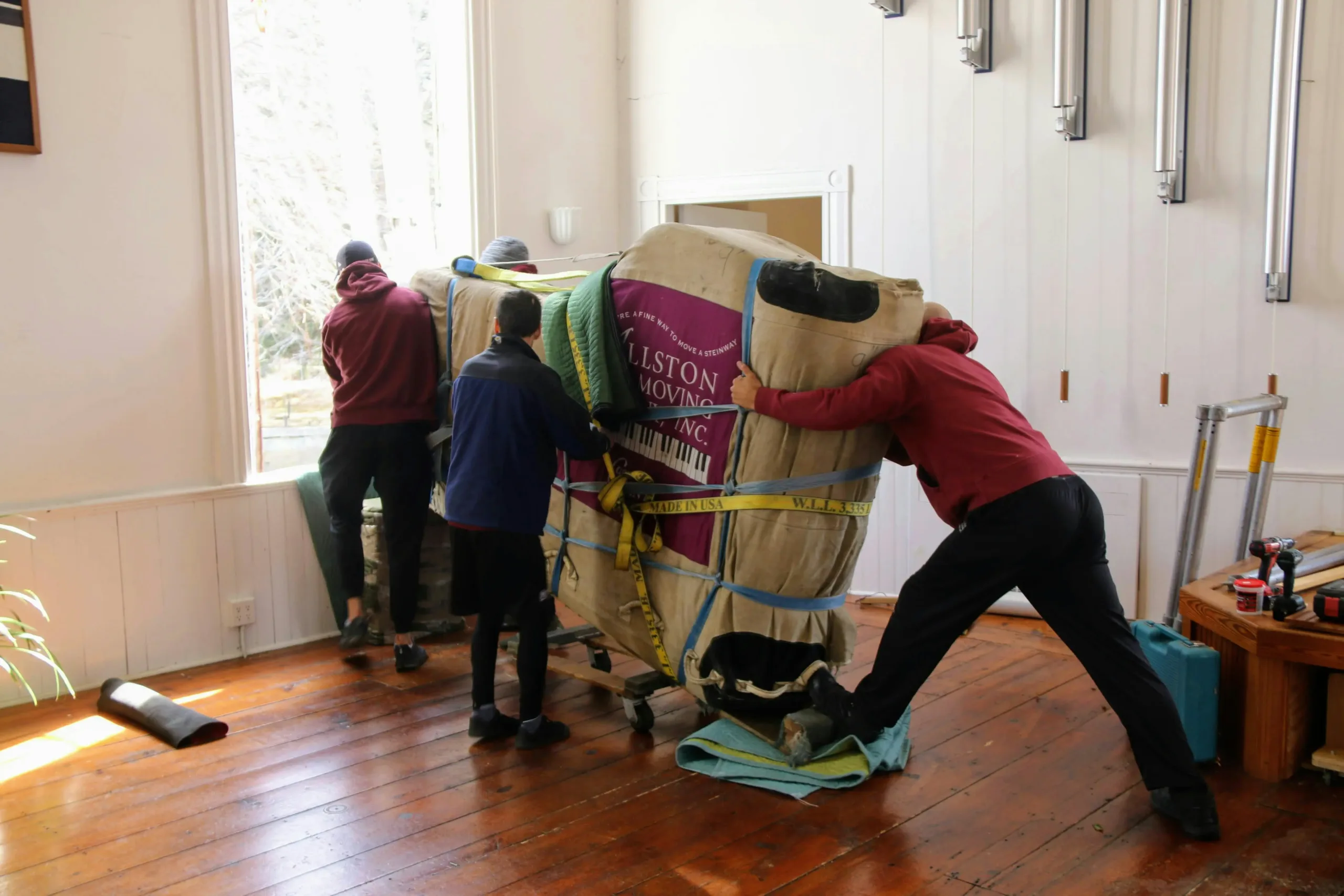 Estate cleanout team removing large unsold furniture items from an empty home in Essex County, NJ